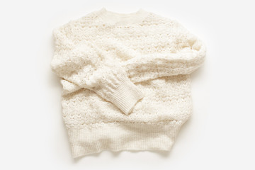  Warm knitted sweater on white background. Minimalistic flatlay