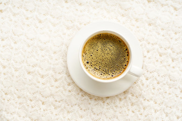 Flatlay with knitted sweater and a cup of coffee