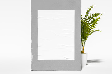 Blank Vertical Poster From Crumpled Paper on Gray Walls Near Green tropical flowers. Flat In Cutaway. 3D rendering.