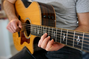 Fototapeta na wymiar Close-up on guitarist's fingers on the guitar fretboard