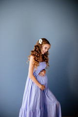 Beautiful pregnant young woman hold her tummy