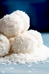 Homemade round candy made from coconut flakes and white chocolate close-up. Set candy truffles snowball, selective focus