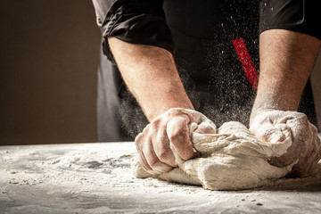 Cooking round bread in flour. Preparation of Easter bread.Men hands