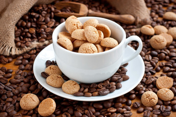 Composition with  coffee cup with  tasty  almond cookies