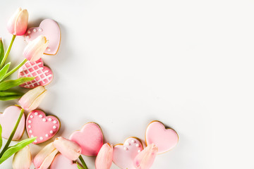 Homemade pick sugar glazed Valentine day cookies. Valentine heart shaped bakings. White stone...