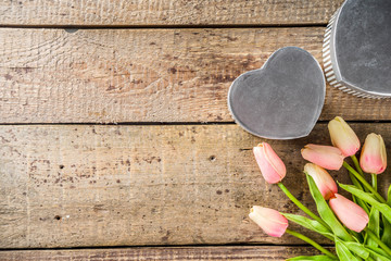 Spring and love concept. Valentine's day greetings background. Bouquet of pink tender tulip flowers on a wooden background. Top view place for text.