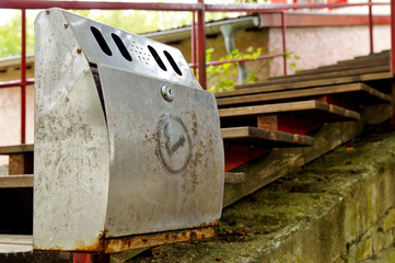 Closeup of an ashtray, mounted on an handrail, for smutting out cigarettes before entrance to the building. Outdoor Smokers Cigarette Bin Ashtray on old metal stairs handrails