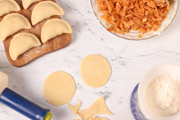Cooking dumplings vareniki with cabbage at home, Traditional dish of Ukrainian cuisine, Top view