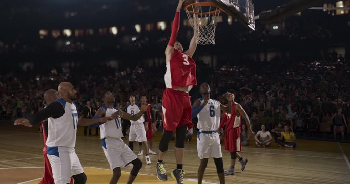 Basketball players on big professional arena during the game. Tense moment of the game. Celebration