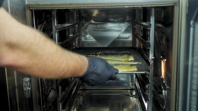 Asian cuisine Fish is cooked in a combi steamer, fish beer snacks, crispy fish, cooking, a cook in the kitchen, a seafood dish