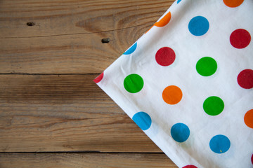 empty wooden table with a bright polka dot towel.