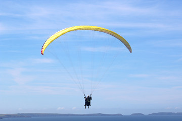 Tandem paraglider flying at Newgale, Wales	