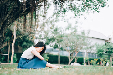 Asian woman sitting alone and depressed,Portrait of tired young woman. Depression