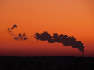 Sunset with smoke coming from a powerplant