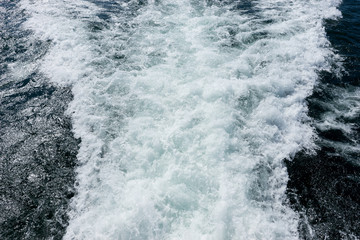 Fototapeta na wymiar Water surface of the sea. View from motor ship stern with ship trace on water