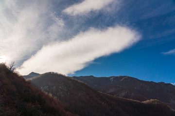 Fluffy cloud over a mountain range