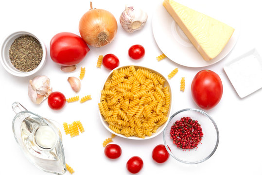 pasta, cherry tomatoes, cheese, pepper, garlic on white background, raw pasta,