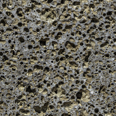 Seamless pattern texture of orange stone pumice with holes is in the photo