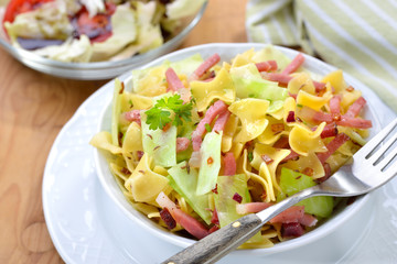 An Austrian pasta meal with fried Tyrolean bacon and white cabbage called Krautfleckerl