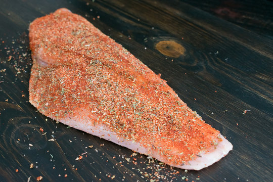 Raw Snapper Fillet Rubbed with Cajun Spices