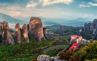 Wonderful view of the rocks and monasteries of Meteora, Greece. Mysterious Sunny Morning with blue sky at sunny day. Awesome Nature Landscape. Amazing Greece. Popular travel location. © jenyateua