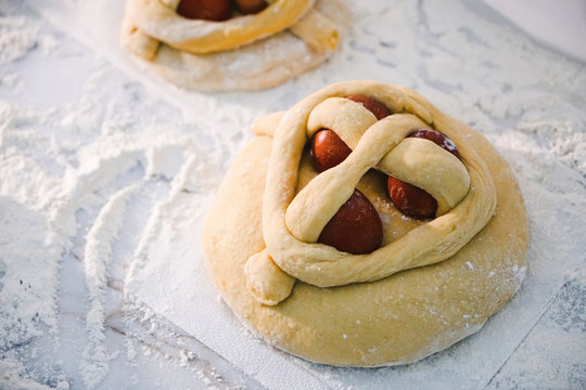 Traditional raw dough Easter cakes, also called folar or Folares on top of a table, ready to cook.