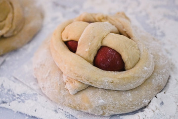 Uncooked Easter cake with four eggs, also called Folar, ready to go to the oven.