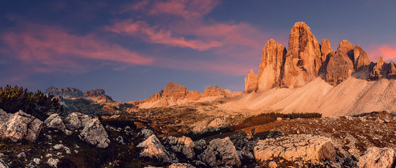 Awesome alpine highlands during Sunset. Amasing nature landscape. Tre Cime di Laveredo, three spectacular mountain peaks with colorful sky,  Dolomites Alps, South Tyrol, Italy. Picture of wild area