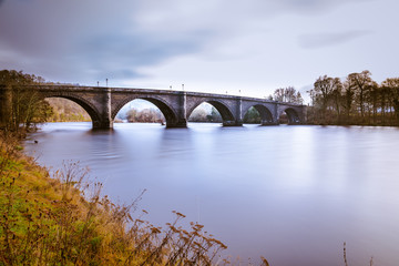 Fototapeta na wymiar Dunkeld bridge over the river Tay in Perthshire, Scotland. Telford's famous bridge over the mighty River Tay, Dunkeld, Perth & Kinross, Scotland, Europe.