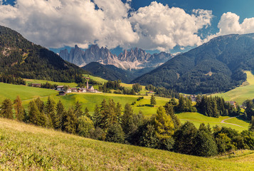 Fototapeta na wymiar Awesome alpine Landscape in sunny day. Santa Maddalena. Is one of the most popular photo spot of Dolomite. Famous World place. Dolomites Alps. Italy. Amazing Natural background. Postcard