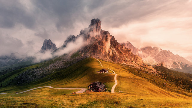 Awesome nature landscape. fantastic view of famous Dolomites mountain peaks glowing in beautiful golden morning light at sunrise in summer. Passo Giau, Dolomites, Italy. Majestic Dolomites Alps