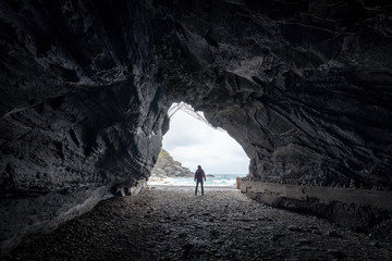 Landscape of cave in Vernazza, Traveler man looking somewhere on sand beach in Cinque Terre, Travel popular place Italy - obrazy, fototapety, plakaty