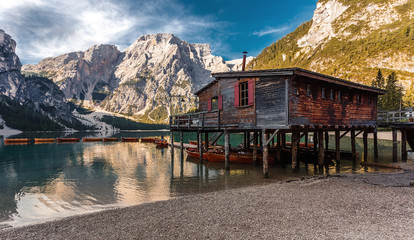 Fototapeta premium Sunny morning at Famouse Mountain Lake in dolomites Alps. Wonderful Braies Lake during sunrise. Amazing Summer Mountain Landscape. Lago di Braies in Spring, Awesome nature Scenery. Pragser wildsee