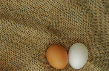 Bio organic eggs over natural gunny fabric full frame background 