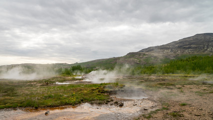 Geothermal area of Strokkur in Iceland with hot boiling thermal water