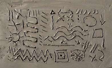 Symbols and signs on grey modelling clay background and texture