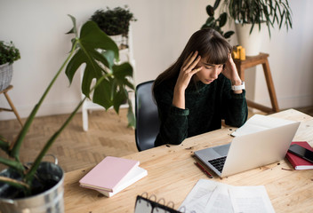Pensive woman freelancer working project, feeling stressed, missed deadlines, headache. Serious...