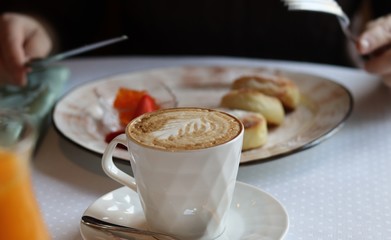 Breakfast in the cafe. Cheesecakes with berries and cup of  coffee