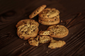 shortbread cookies with peanuts and chocolate on a wooden brown background. close-up.