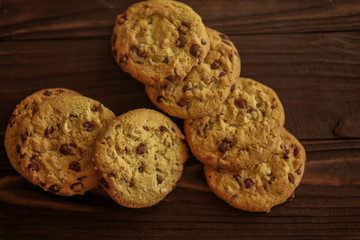 shortbread cookies with peanuts and chocolate on a wooden brown background. close-up.