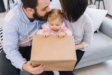 Parents present their first year's present to their one-year-old daughter