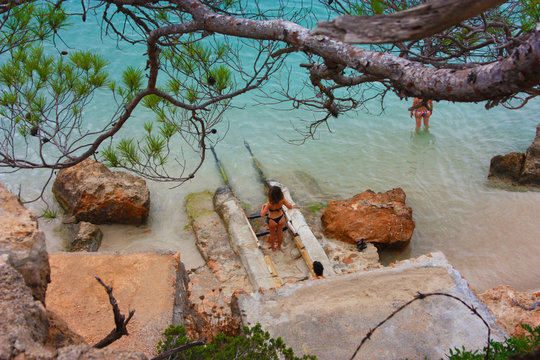 the beautiful and famous bay of cala saladeta of ibiza seen from above or rocky inlet between the rocks and the vegetation of the balearics