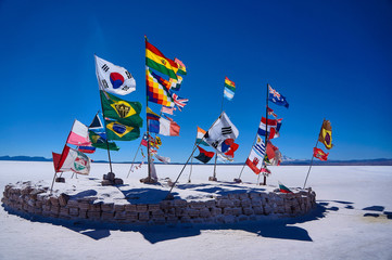 Flags in the Salar de Uyuni, Bolivia - obrazy, fototapety, plakaty