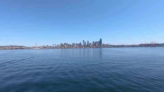 Sailing across Pacific ocean with scenic panorama of Seattle city, slow motion