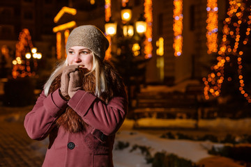 Smiling winter woman in night city