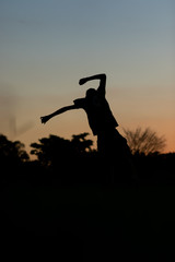 silhouette of a man jumping in sunset
