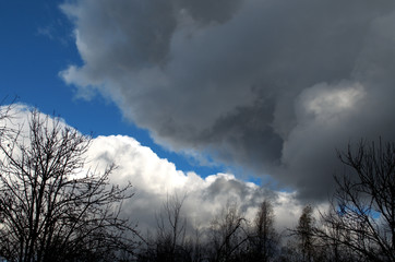 Blue sky before a strong storm with black clouds