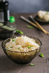 Pickled and fermented white mushroom (Tremella fuciformis) in a glass plate on a dark background.