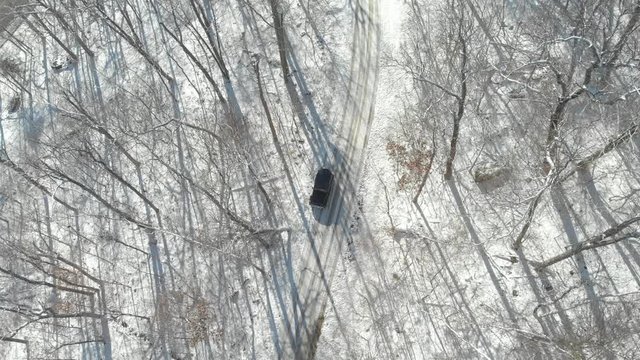 Aerial of Vehicle Parked on Trail with Snow