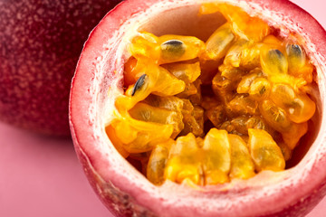 Passion fruit on a pink background, close-up, isolated, top view